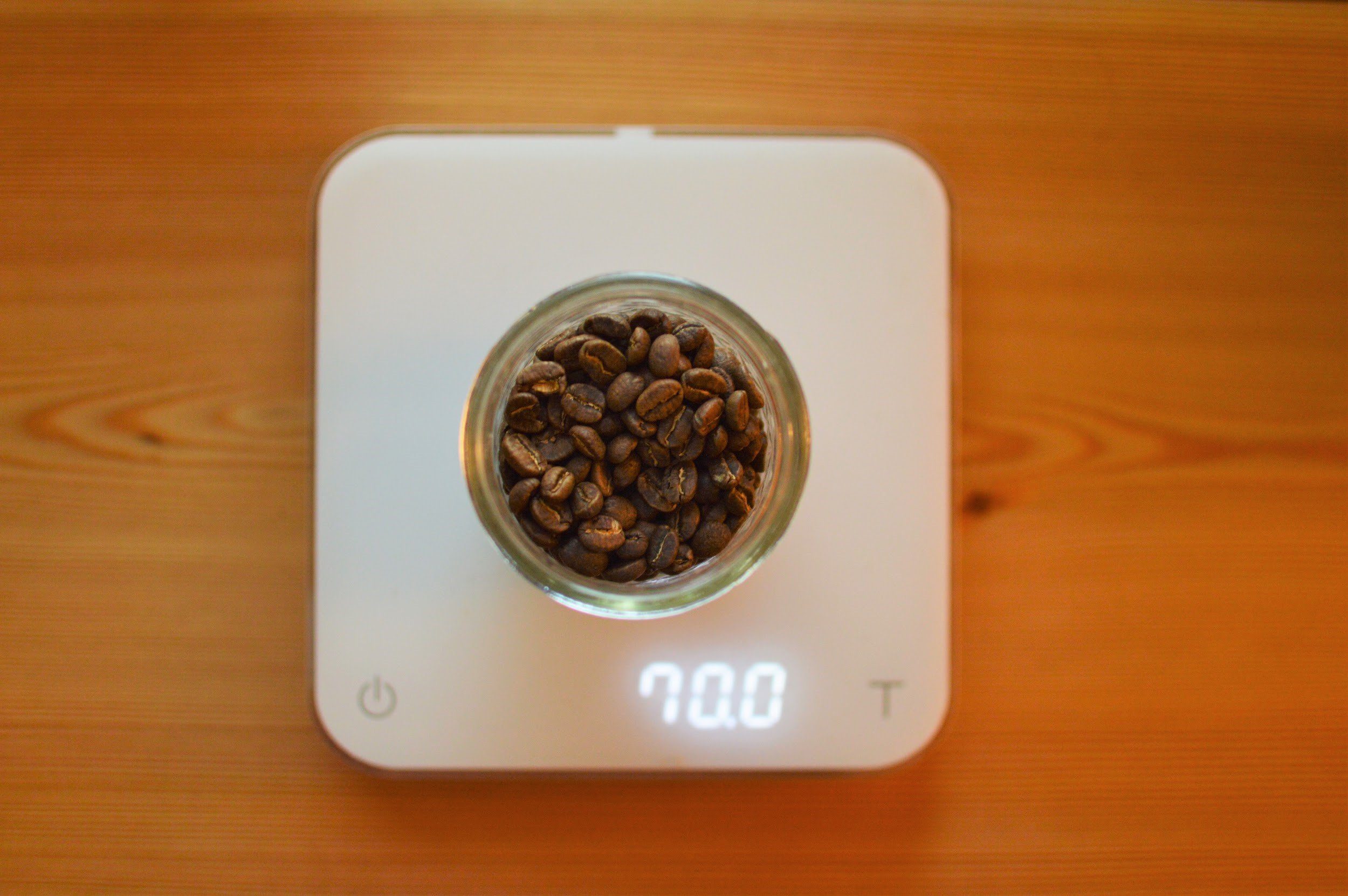 Coffee Beans Inside Shot Glass On Weight Scale With Empty Coffee