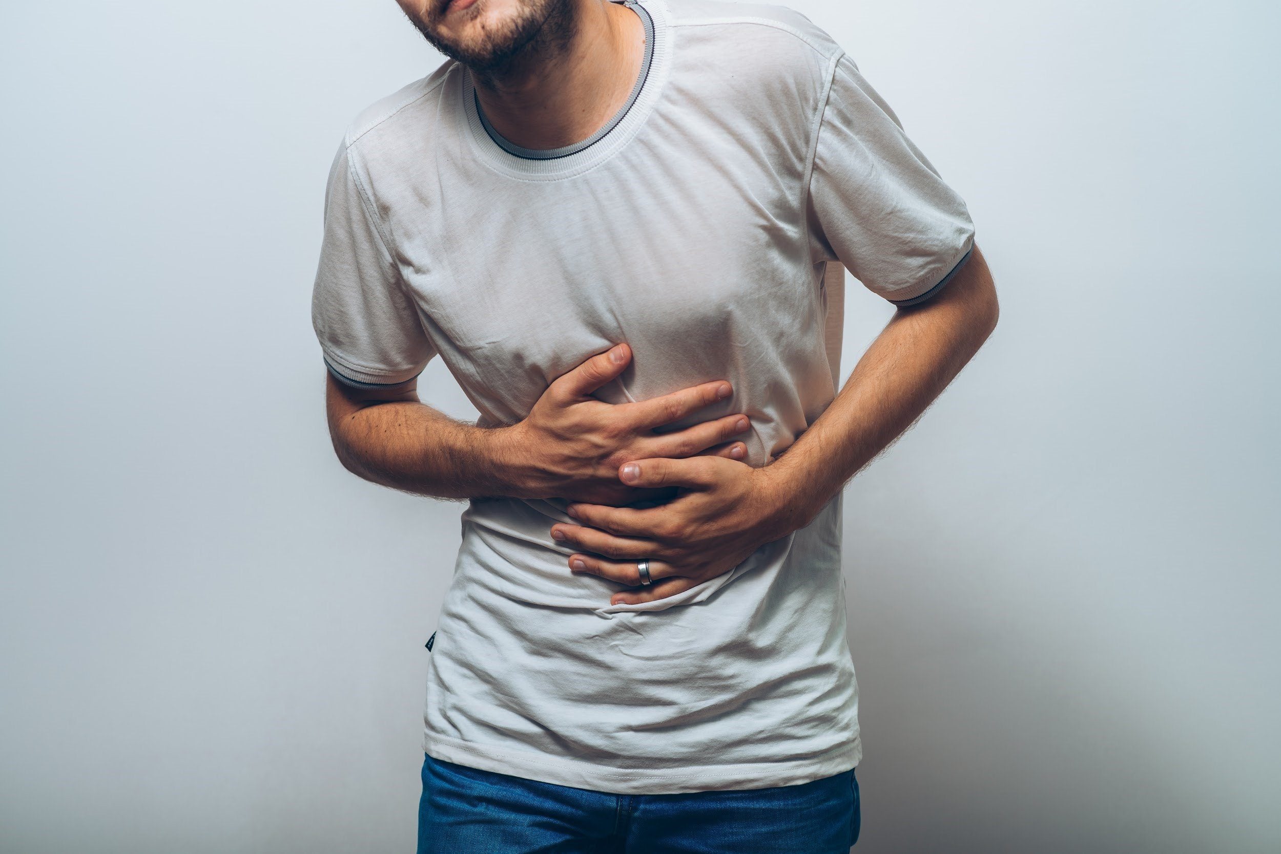 Coffee Upset Stomach? Why It Happens & How to Fix It 2 A man holding his stomach, showing how coffee can cause an upset stomach